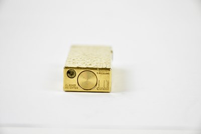 Lot 17 - DUNHILL; a gold plated textured rectangular...