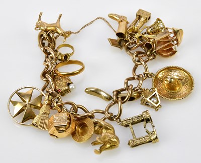 Lot 492 - A substantial 9ct yellow gold charm bracelet...