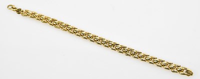 Lot 520 - A yellow metal flat link bracelet, length 19cm,...