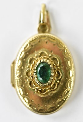 Lot 447 - A 9ct yellow gold oval locket pendant set with...