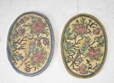 Lot 605 - A pair of 18th/19th century Persian oval tiles,...