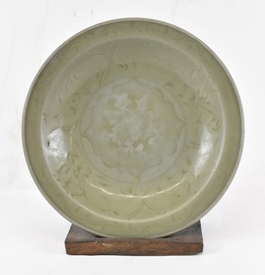 Lot 628 - An 18th century Persian celadon glazed shallow...