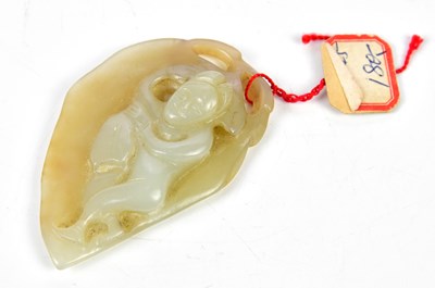 Lot 1057 - A Chinese jade carving of a figure lying upon...