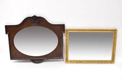 Lot 85 - A mahogany carved wall mirror with oval...