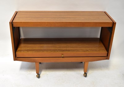 Lot 27 - A mid-20th century metamorphic sideboard/table,...