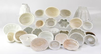 Lot 282 - A collection of white pottery jelly moulds of...