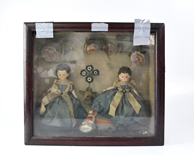 Lot 468 - A diorama containing two Victorian dolls in...