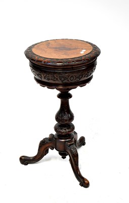Lot 37 - A Victorian walnut teapoy with circular carved top
