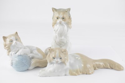 Lot 346 - NAO; three porcelain cat figures, height of...