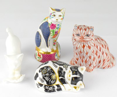 Lot 401 - Four porcelain cat figures comprising a Royal...