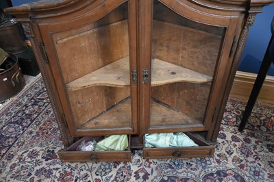 Lot 34 - A French glazed corner cabinet with two doors...