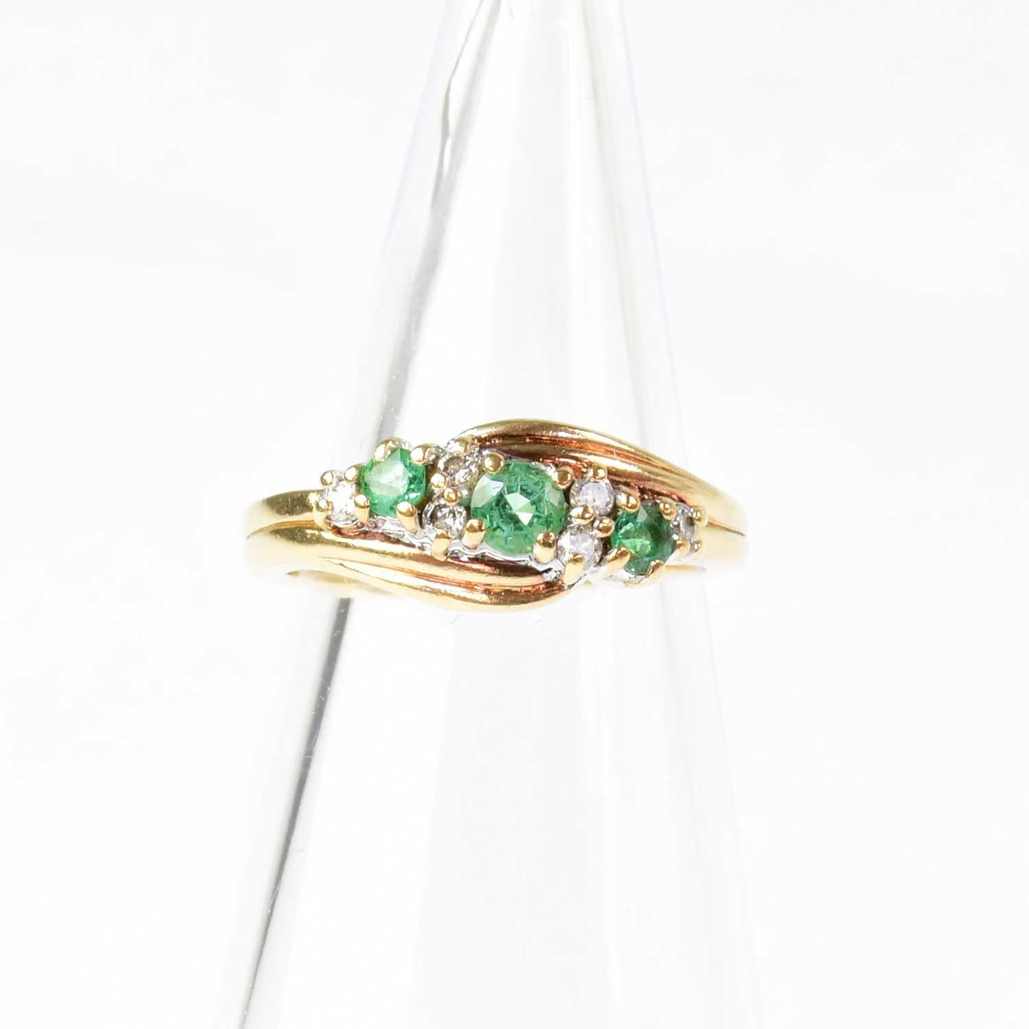 Lot 887 - A 9ct gold ring set with three emeralds