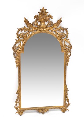 Lot 90 - A gilt framed arched top wall mirror with vase...