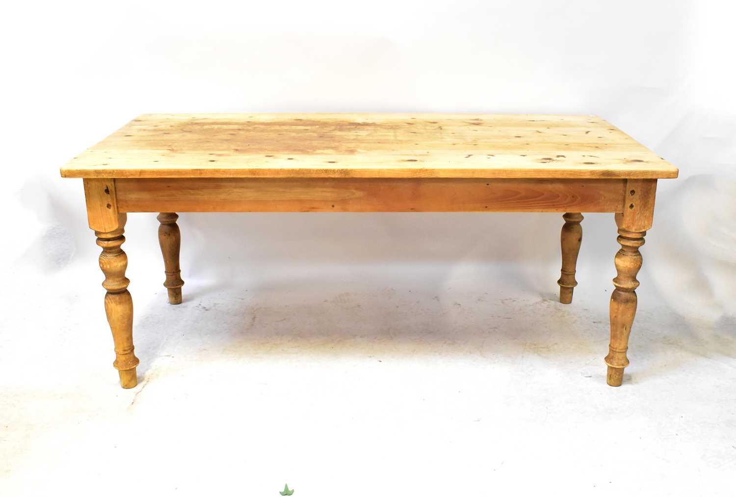 Lot 26 - A pine kitchen table with rectangular top and...