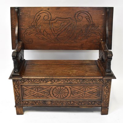 Lot 44 - A mid-20th century carved oak monks' bench,...