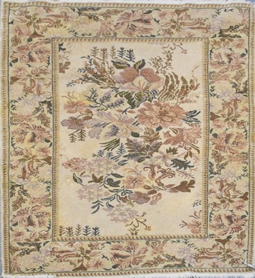 Lot 132 - A modern floral decorated beige ground carpet,...