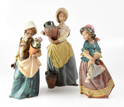 Lot 606 - LLADRÓ; three matte finish figures of girls,...