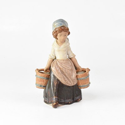 Lot 591 - LLADRÓ; a figure of a young lady carrying two...