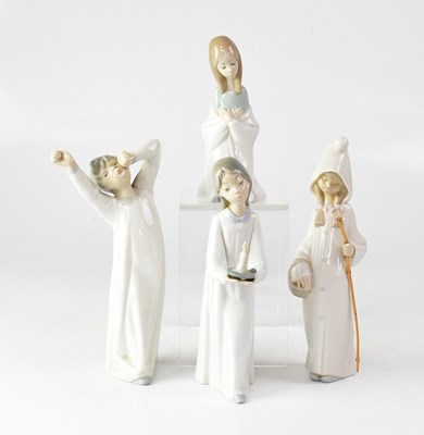 Lot 601 - LLADRÓ; four figures of children in nightgowns,...