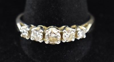 Lot 880 - An 18ct white gold five stone diamond ring,...