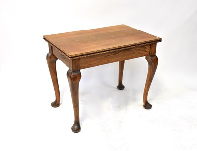 Lot 42 - An early 20th century oak fold-over dining...