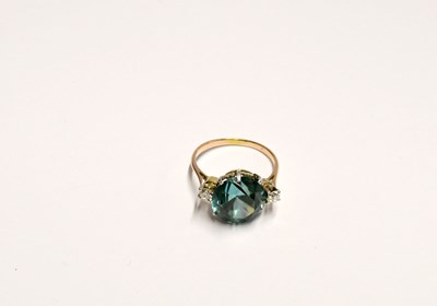 Lot 1083 - A yellow metal cocktail ring set with blue brilliant cut topaz