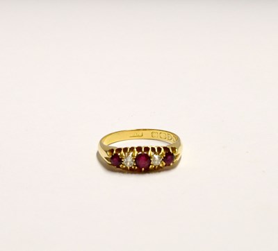 Lot 1014 - An 18ct gold ring set with three rubies and two diamonds