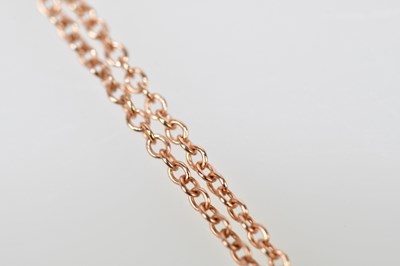 Lot 465 - A 9ct rose gold fine link chain supporting an...