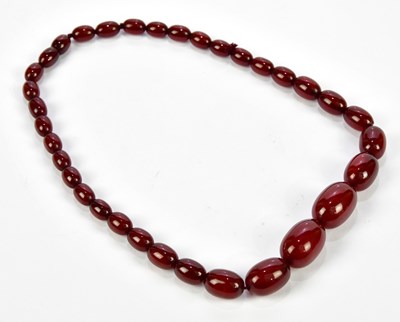 Lot 1033 - A cherry amber coloured necklace, approx...