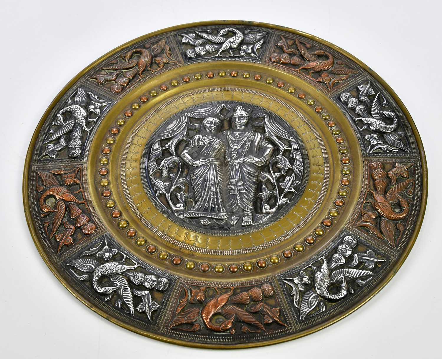 Lot 1194 An Eastern mixed metal plate decorated with