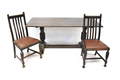 Lot 21 - An early 20th century oak dining room suite...