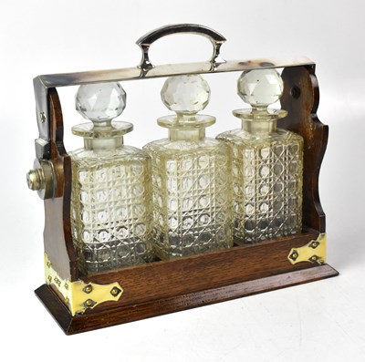 Lot 170 - An oak tantalus with silver plated fittings,...