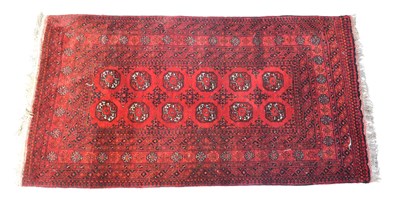 Lot 102 - Four red ground hand knotted carpets (4).