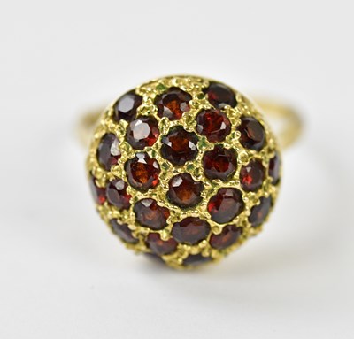 Lot 297 - A 9ct yellow gold garnet set dress ring, size...