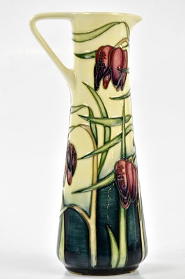 Lot 126 - EMMA BOSSONS FOR MOORCROFT; a ewer decorated...