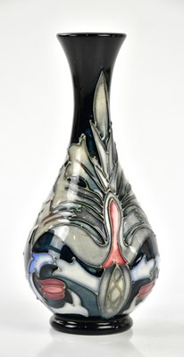 Lot 150 - MOORCROFT; a small baluster vase decorated in...