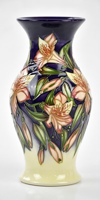 Lot 115 - MOORCROFT; a vase with flared neck decorated...