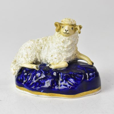 Lot 370 - A Staffordshire model of a recumbent sheep on...