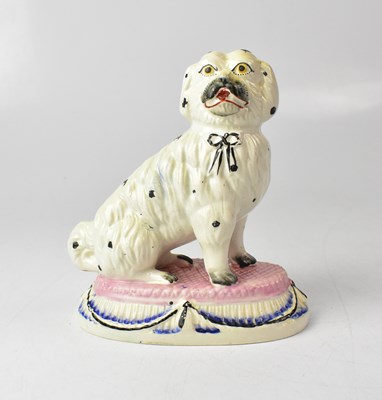 Lot 386 - A c.1865 Staffordshire figure of a Maltese dog,...