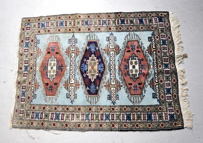 Lot 93 - A hand knotted blue ground rug with geometric...
