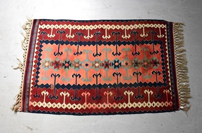 Lot 96 - A red ground Kilim rug with geometric...