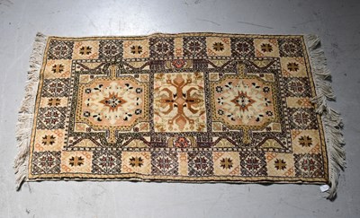 Lot 95 - A beige ground rug with floral medallions...