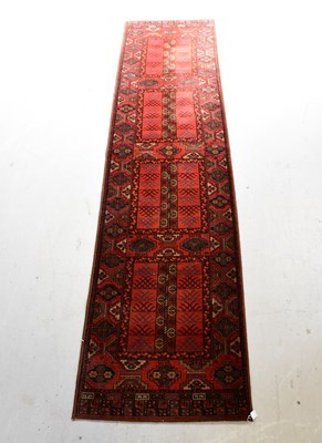 Lot 101 - A red ground runner with geometric pattern,...