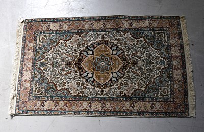 Lot 97 - A beige ground silk mix rug with central...