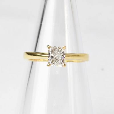 Lot 1043 - An 18ct gold diamond solitaire ring set with a...