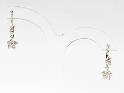 Lot 1117 - A pair of 18ct white gold drop earrings set...