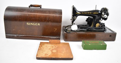 Lot 424 - A cased Singer sewing machine.