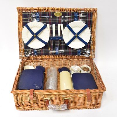 Lot 145 - A Harrods wicker picnic basket containing a...