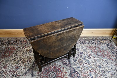 Lot 6525 - An 18th century oak oval drop-leaf table with...