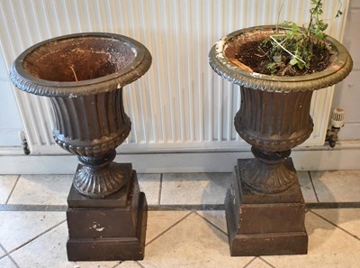 Lot 151 - A pair of cast iron campana formed garden urns...